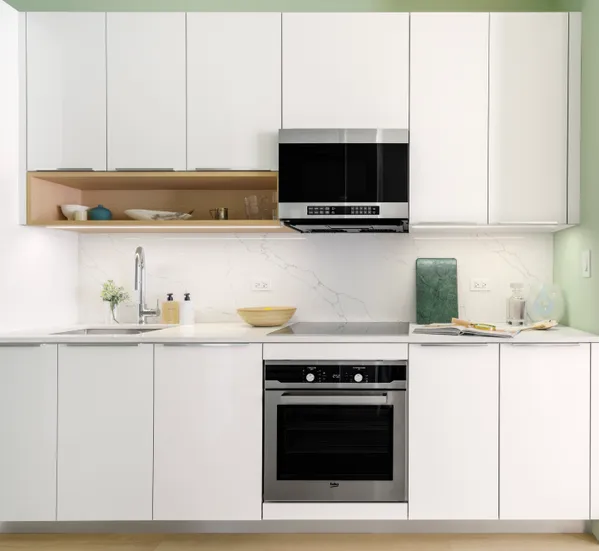 a kitchen with stainless steel appliances granite countertop a sink and a microwave