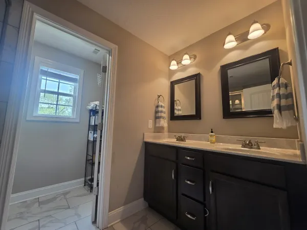 a bathroom with a double vanity sink and mirror