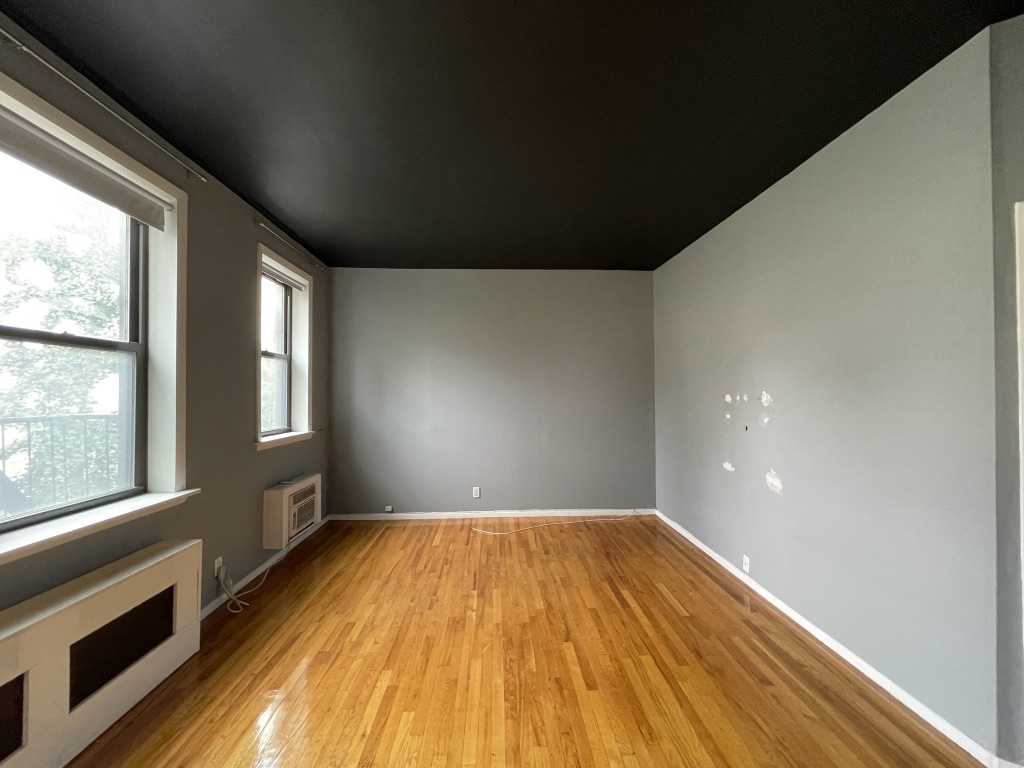 266 West 22nd Street, Unit 2 Manhattan, NY 10011 - Photo 6 of 14 a view of empty room with wooden floor and fan