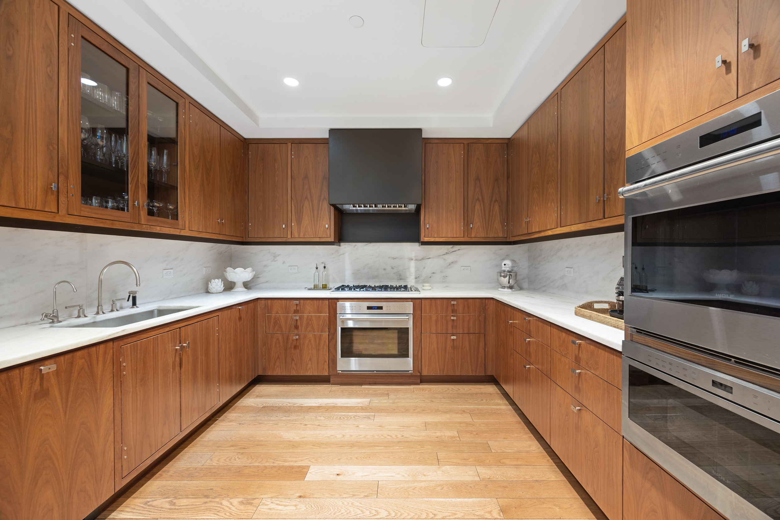 71 Laight Street, Unit 2F Manhattan, NY 10013 - Photo 5 of 20 a kitchen with granite countertop wooden cabinets stainless steel appliances and a counter space