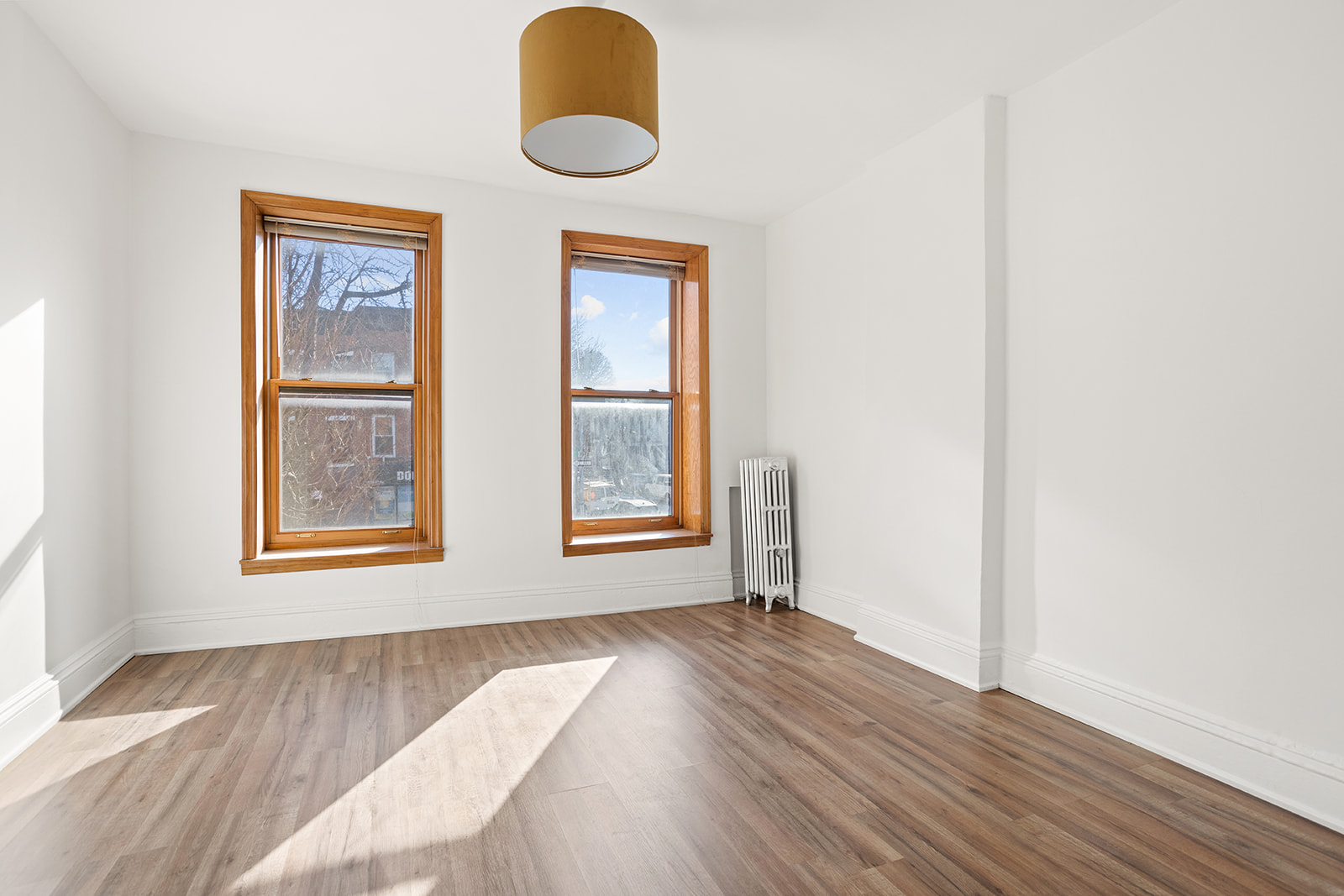 1682 8th Avenue Brooklyn, NY 11215 - Photo 10 of 16 a view of an empty room and wooden floor