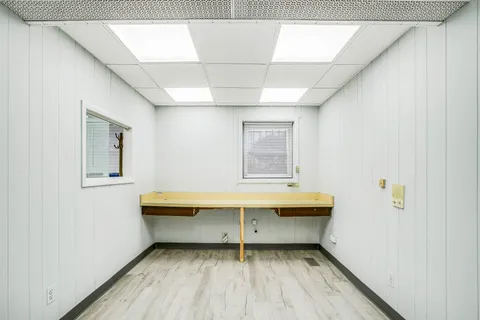 a view of a room with wooden floor and window