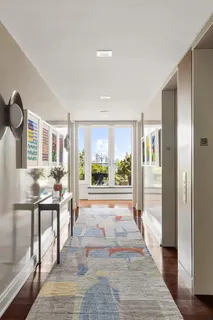 a very nice looking room with a large window and wooden floor