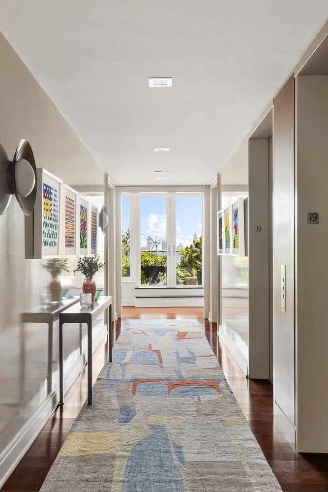 a very nice looking room with a large window and wooden floor