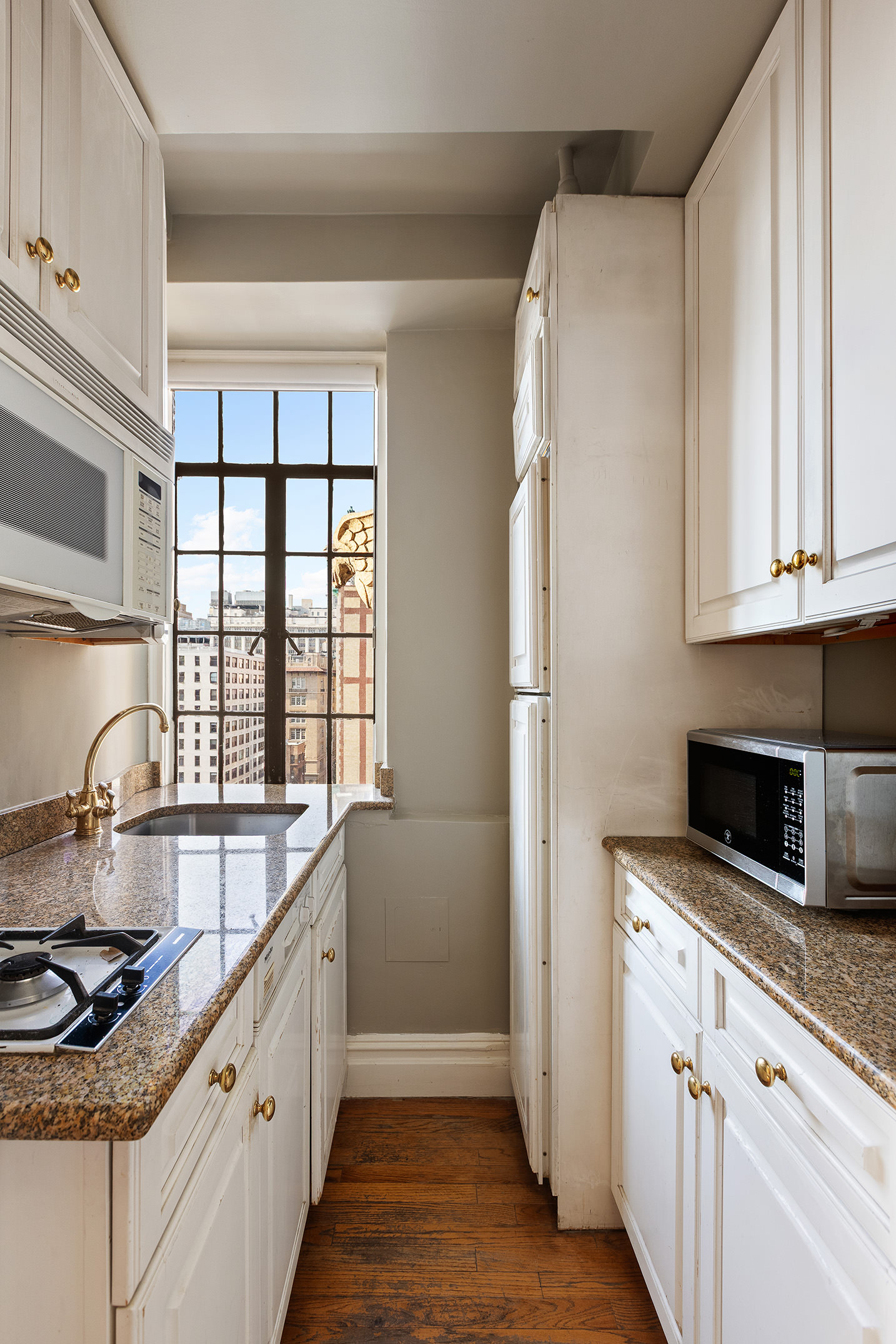 81 Irving Place, Unit 15DE Manhattan, NY 10003 - Photo 5 of 18 a kitchen with granite countertop a sink a stove and cabinets