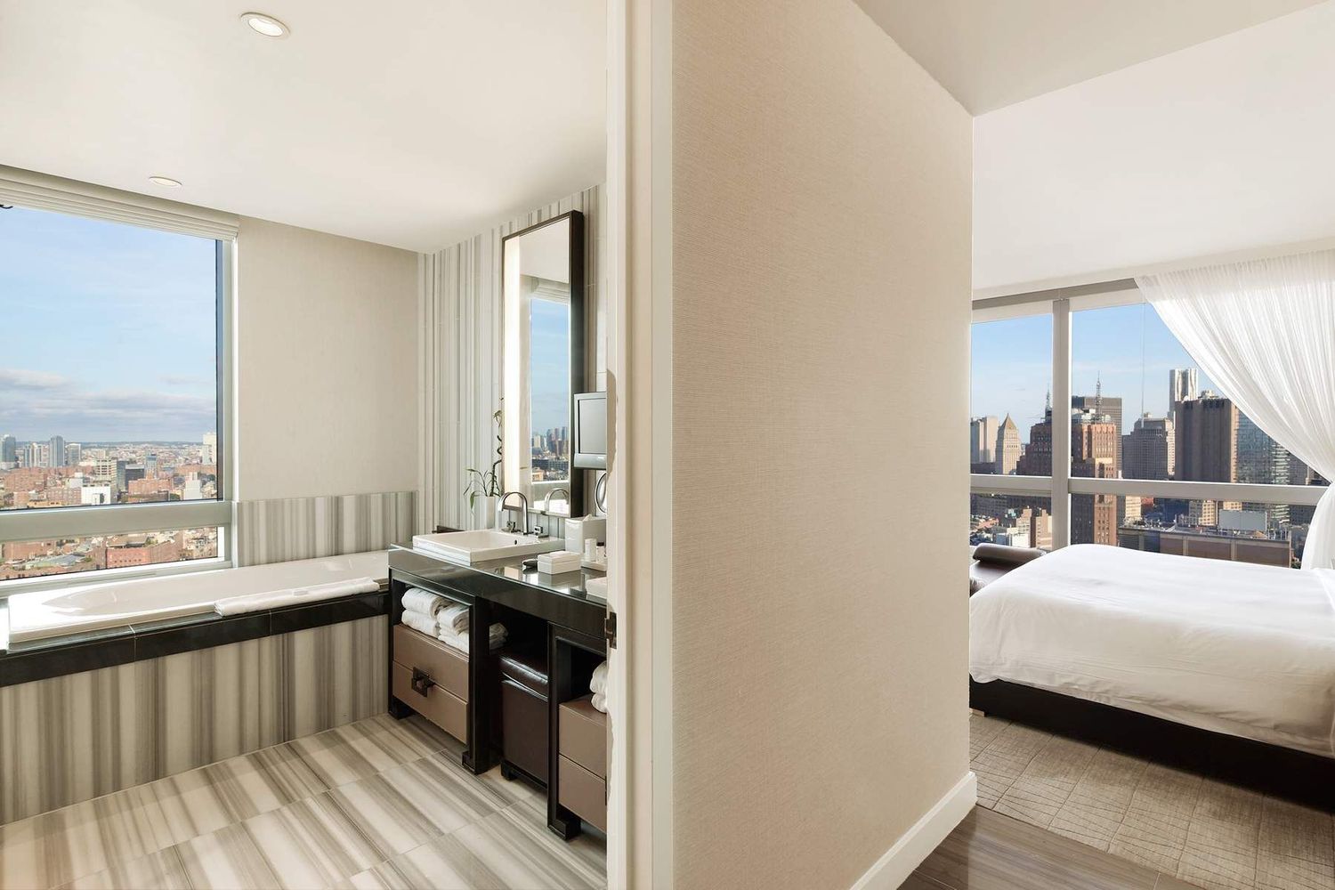 246 Spring Street, Unit 4103 Manhattan, NY 10013 - Photo 4 of 20 a view of a bedroom with furniture and windows