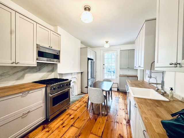 446 Sackett Street Brooklyn, NY 11231 - Photo 3 of 15 a kitchen with stainless steel appliances granite countertop a stove top oven a sink dishwasher and white cabinets with wooden floor
