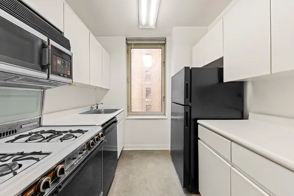 a kitchen with a stove microwave and refrigerator