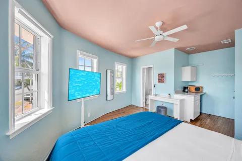 a bedroom with a bed and a desk with stool