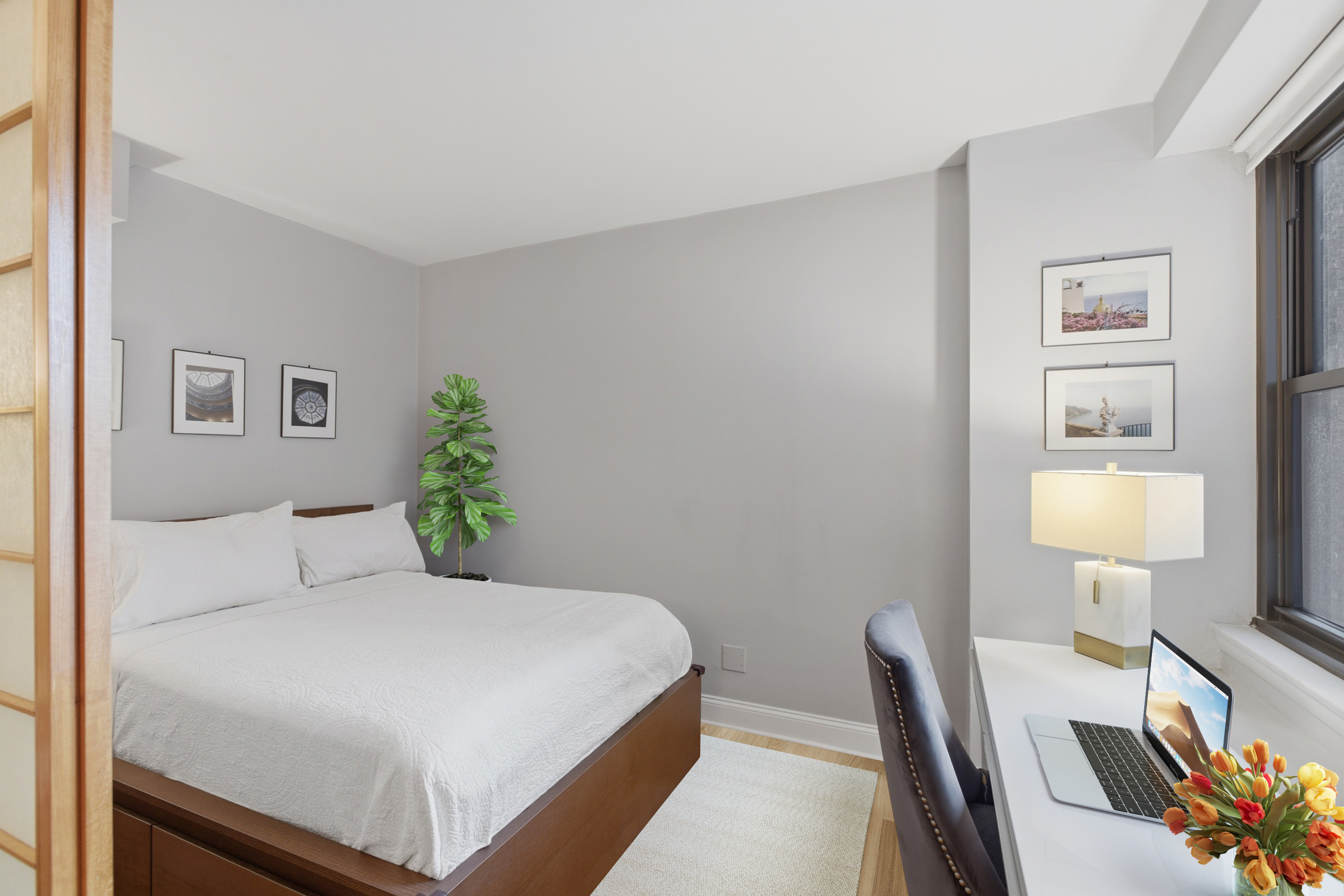 345 East 81st Street, Unit 12G Manhattan, NY 10028 - Photo 3 of 8 a bedroom with a bed and a lamp on table
