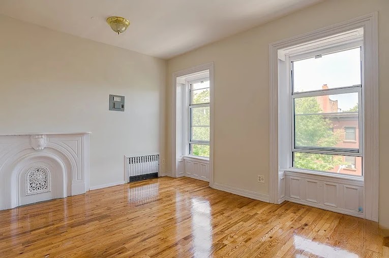 224 Cumberland Street, Unit 4 Brooklyn, NY 11205 - Photo 3 of 5 a view of empty room with wooden floor and fan