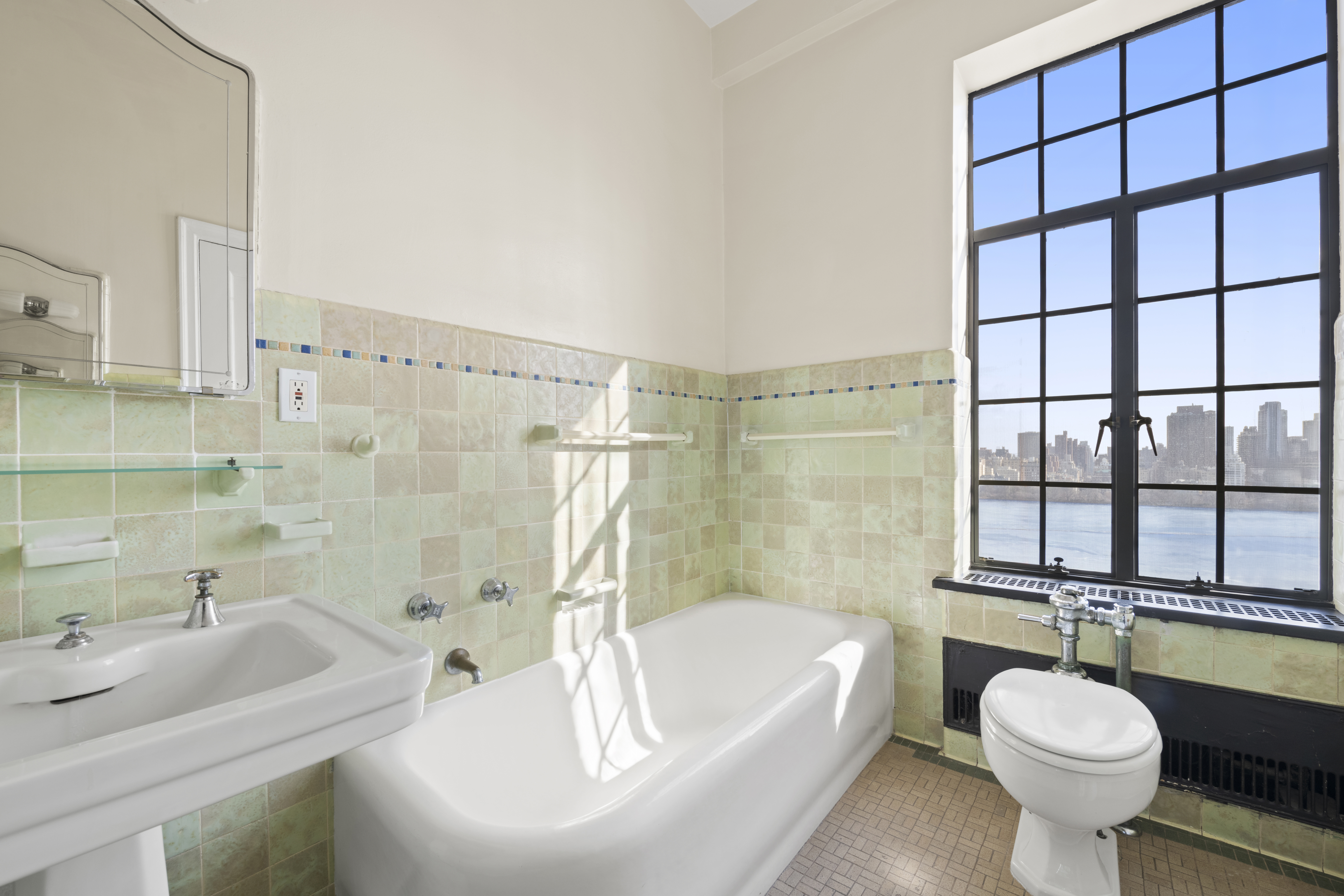 300 Central Park West, Unit 21G Manhattan, NY 10024 - Photo 13 of 21 a bathroom with a sink toilet a shower and bathtub