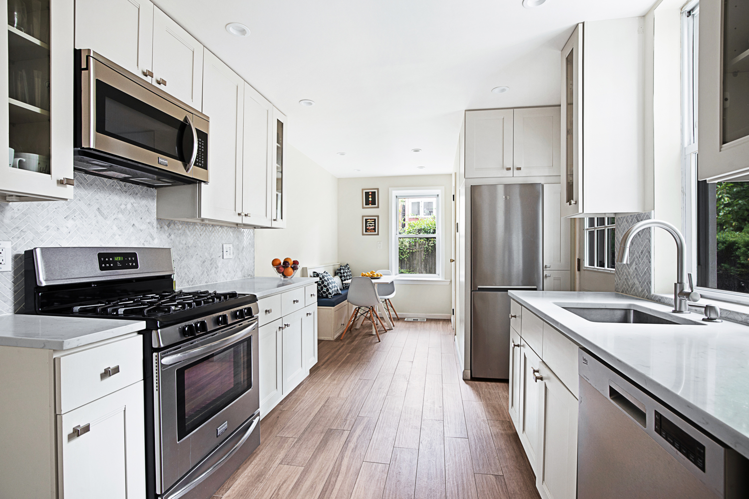 392 9th Street Brooklyn, NY 11215 - Photo 4 of 11 a kitchen with stainless steel appliances a white stove top oven a refrigerator a sink and dishwasher with wooden floor