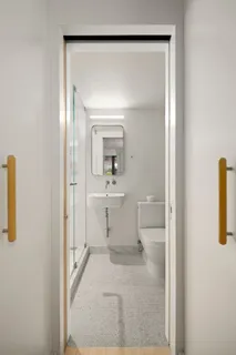 a bathroom with a sink a toilet and a mirror