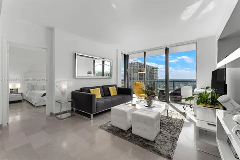 a living room with furniture large window and a flat screen tv