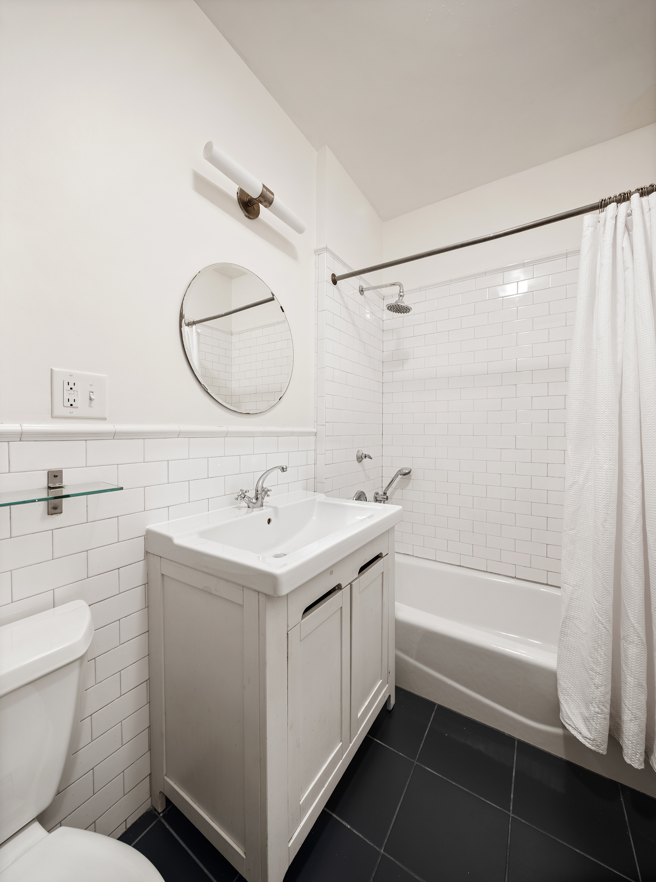 195 Lefferts Avenue Brooklyn, NY 11225 - Photo 14 of 18 a bathroom with a sink a toilet and shower