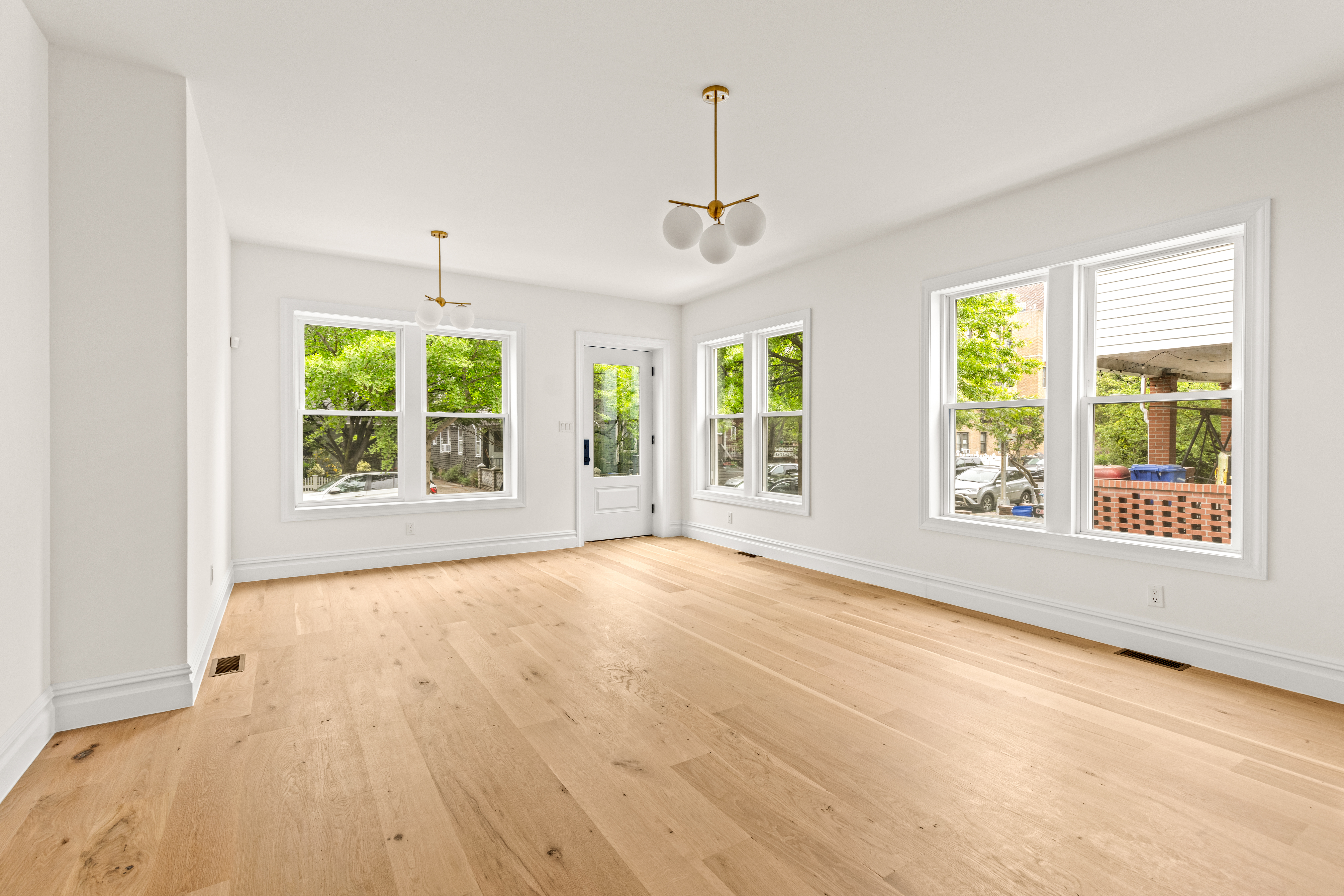 409 East 4th Street Brooklyn, NY 11218 - Photo 16 of 19 a view of an empty room with a window and wooden floor