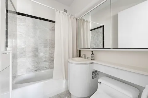 a bathroom with a bathtub and a sink