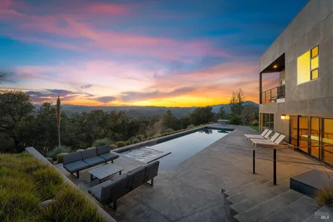 a view of a terrace with couches and sky view