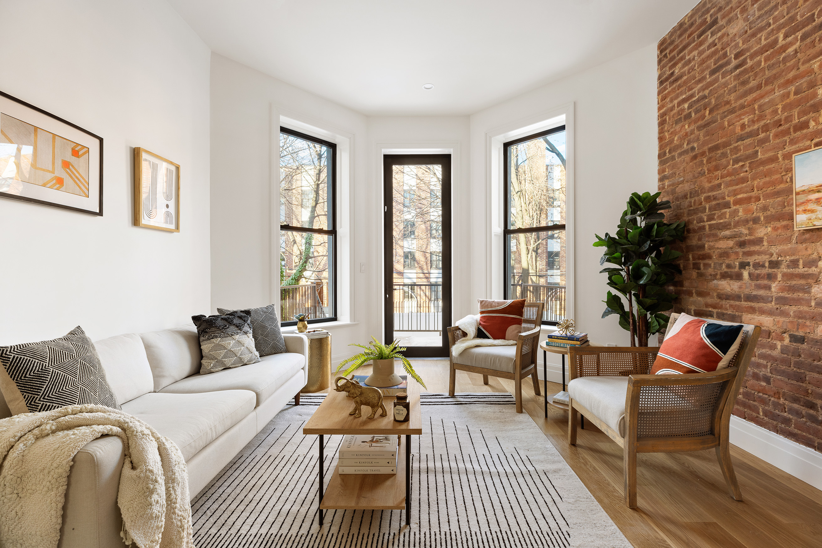 a living room with furniture wooden floor and a large window