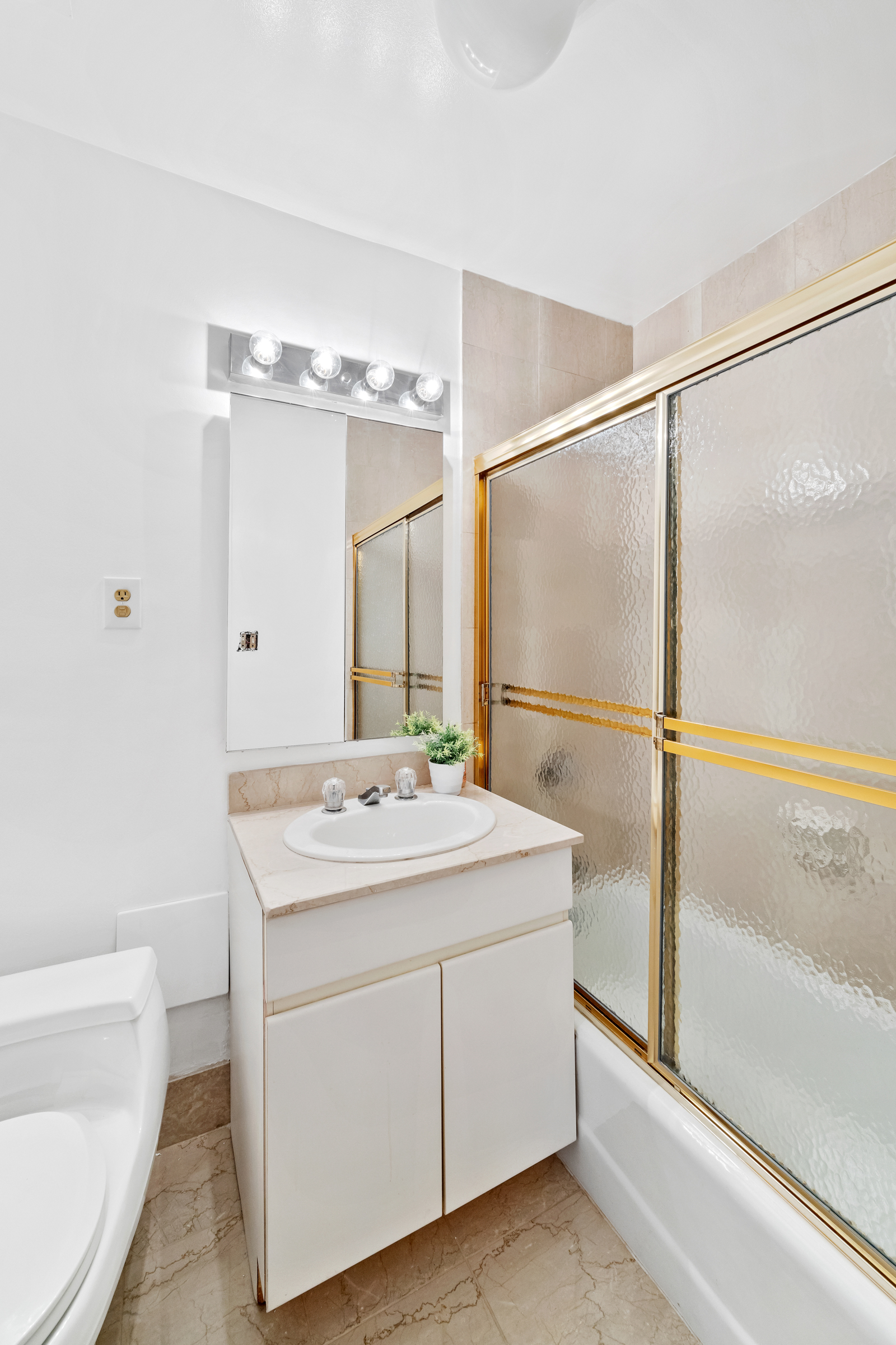 196 6th Avenue, Unit 5A Manhattan, NY 10013 - Photo 8 of 12 a bathroom with a sink and mirror with bathtub