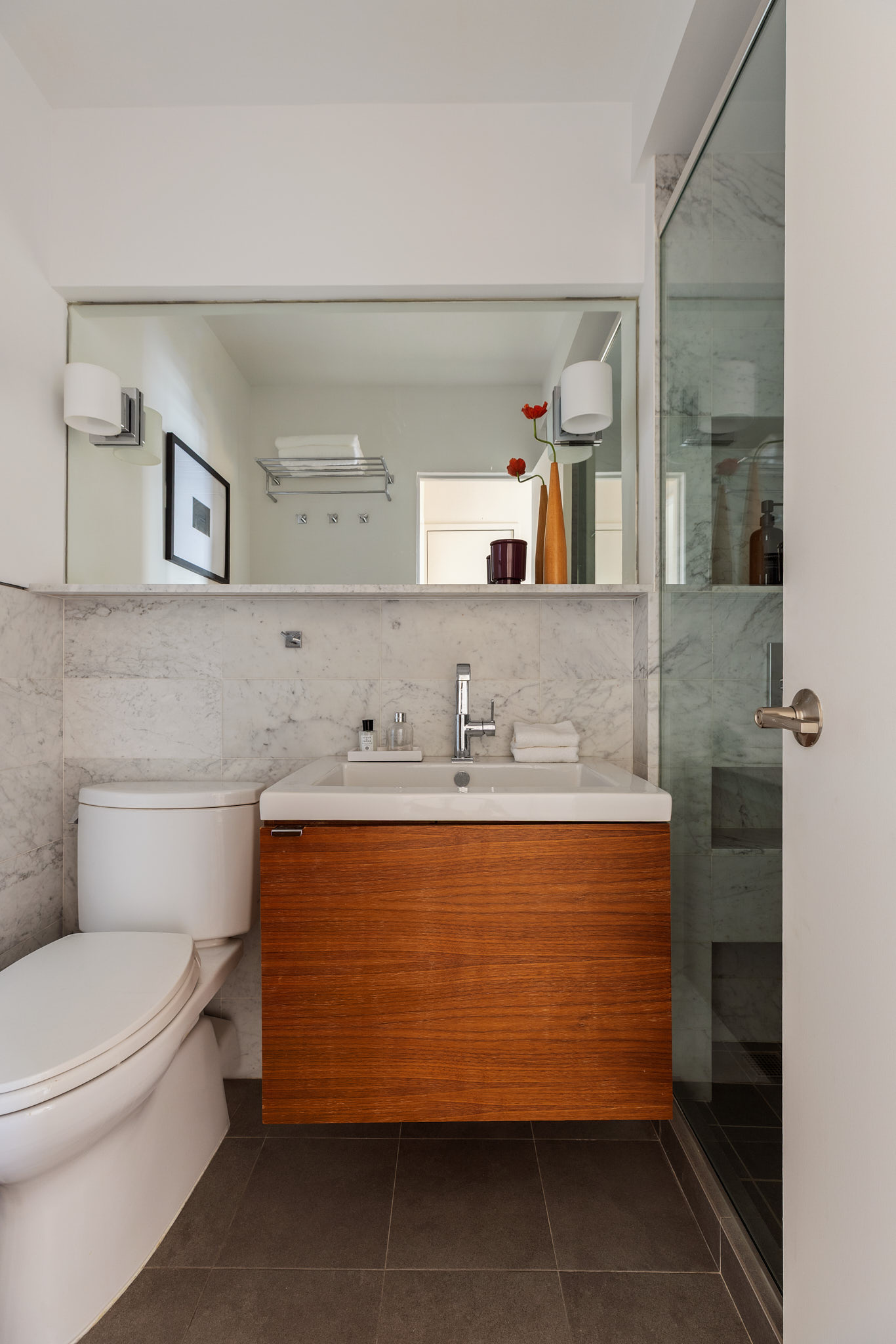 31 Jane Street, Unit 16G Manhattan, NY 10014 - Photo 16 of 20 a bathroom with a sink mirror vanity and toilet
