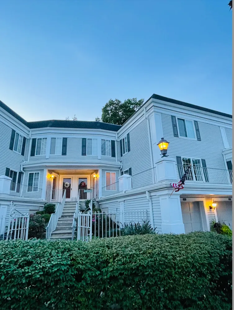 a backyard of a house with lots of green space and fountain