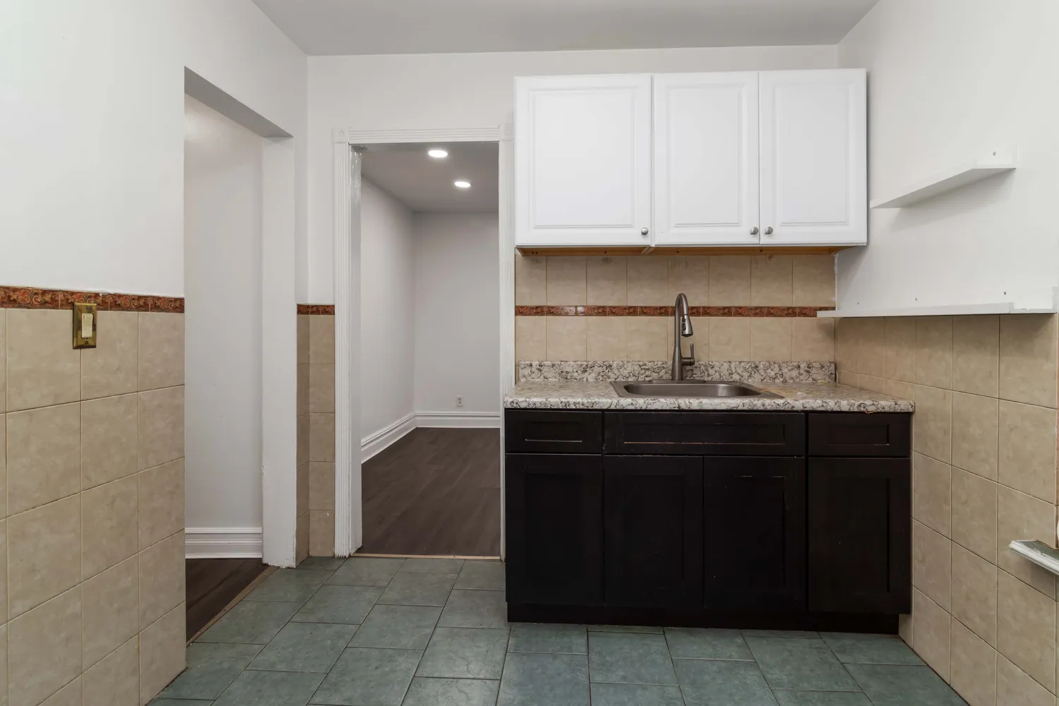 a kitchen with a sink and cabinets