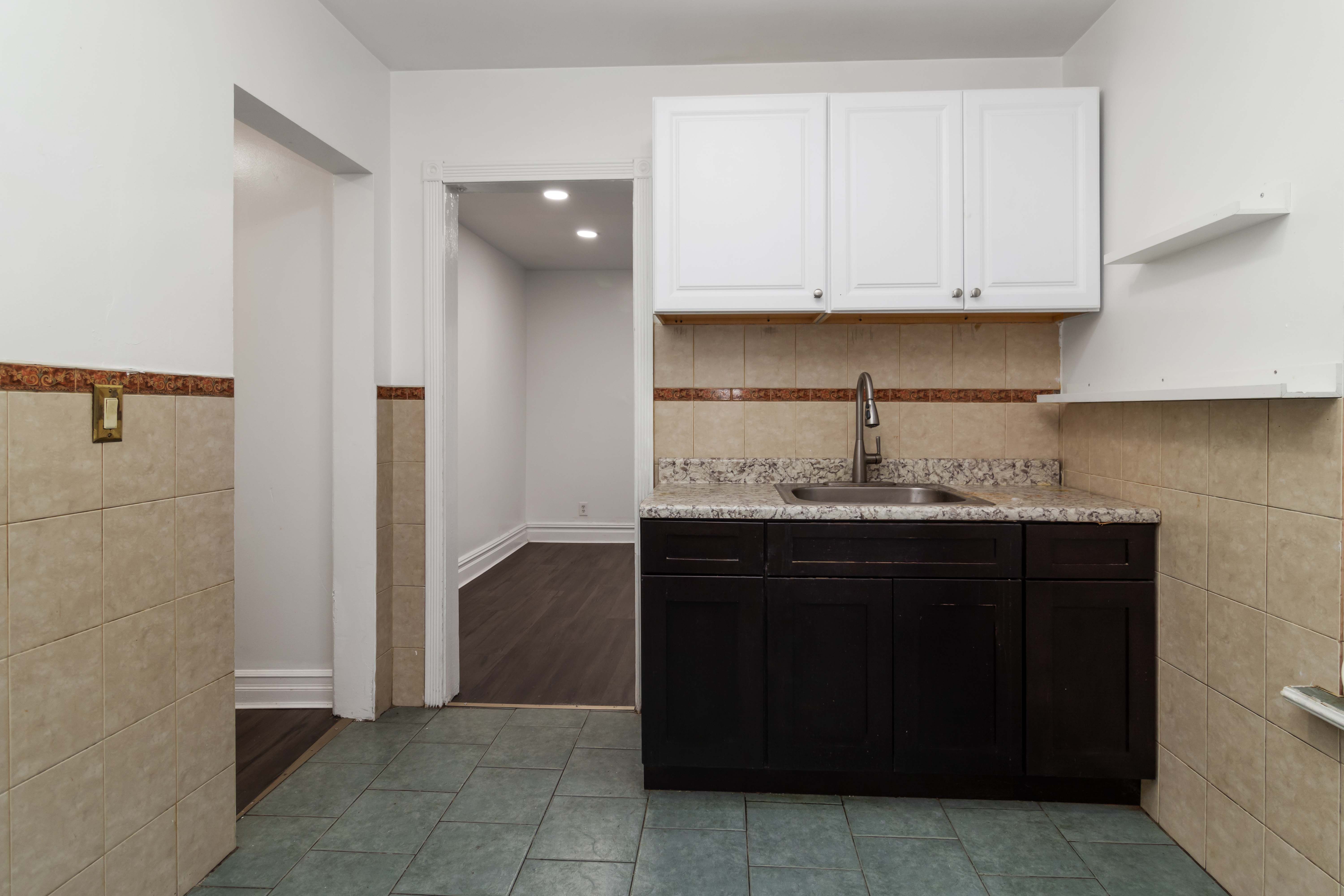 31-24 Steinway Street, Unit 2 Queens, NY 11103 - Photo 1 of 8 a kitchen with a sink and cabinets