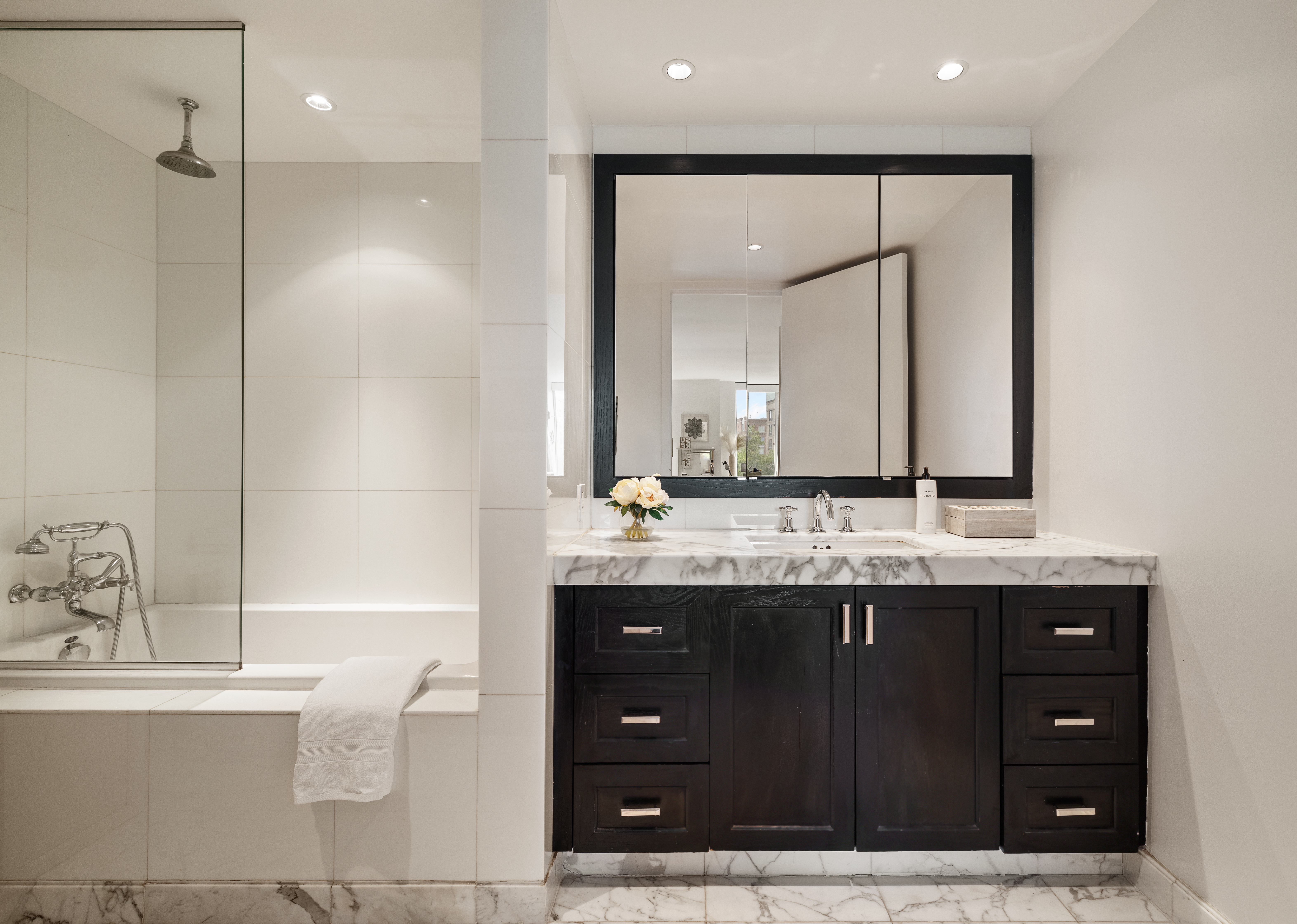 333 Rector Place, Unit 605 Manhattan, NY 10280 - Photo 5 of 13 a bathroom with a granite countertop sink and a mirror