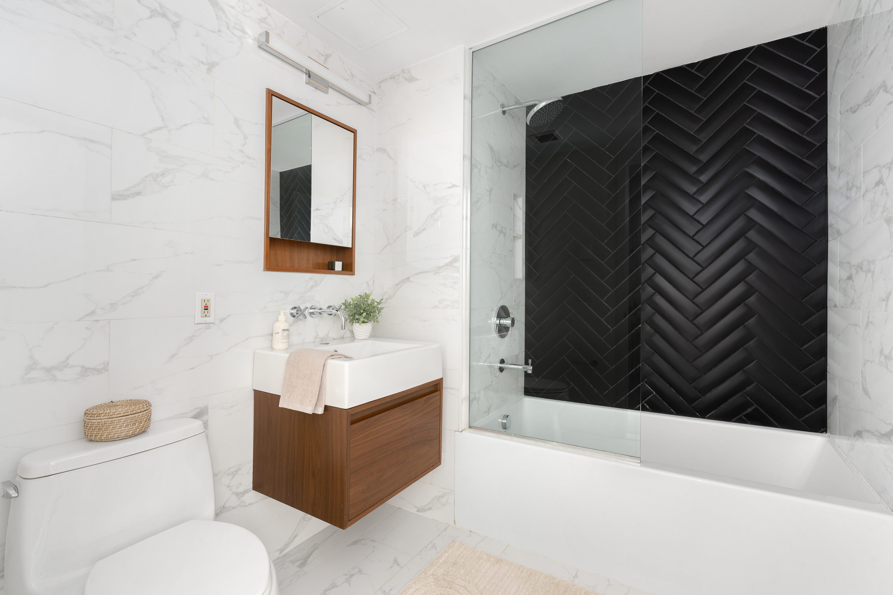 169 Eagle Street, Unit 1A Brooklyn, NY 11222 - Photo 7 of 9 a bathroom with a sink a toilet and mirror