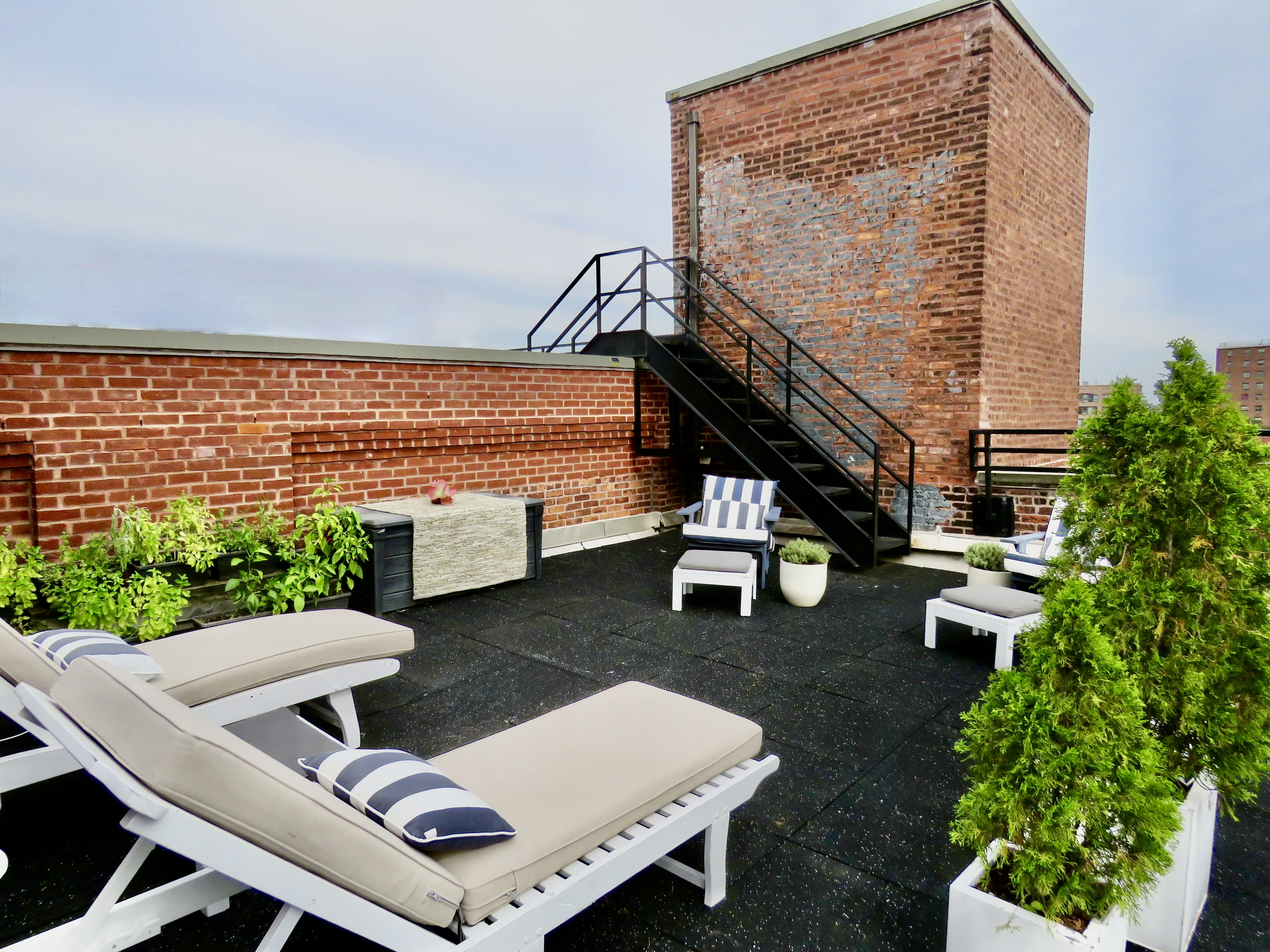 372 Dekalb Avenue, Unit 6E Brooklyn, NY 11205 - Photo 14 of 16 a view of a patio with lawn chairs next to a yard