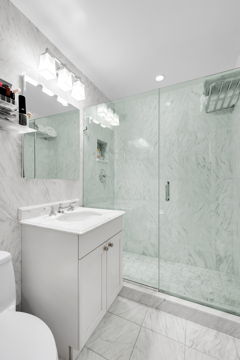 900 Park Avenue, Unit 10B Manhattan, NY 10075 - Photo 6 of 11 a bathroom with a sink shower and a mirror