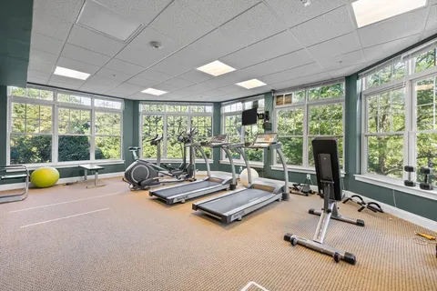 a room with gym equipment and a large window