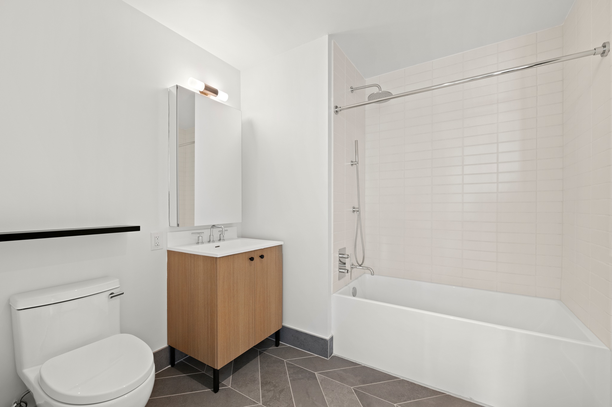 160 Front Street, Unit 706 Brooklyn, NY 11201 - Photo 11 of 17 a bathroom with a toilet a sink and bathtub