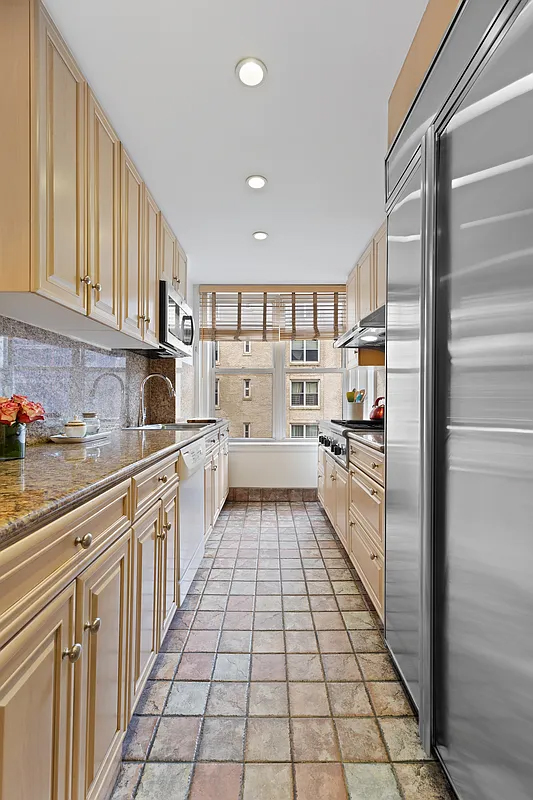 415 Central Park West, Unit 6A Manhattan, NY 10025 - Photo 13 of 25 a kitchen with stainless steel appliances a refrigerator and a sink