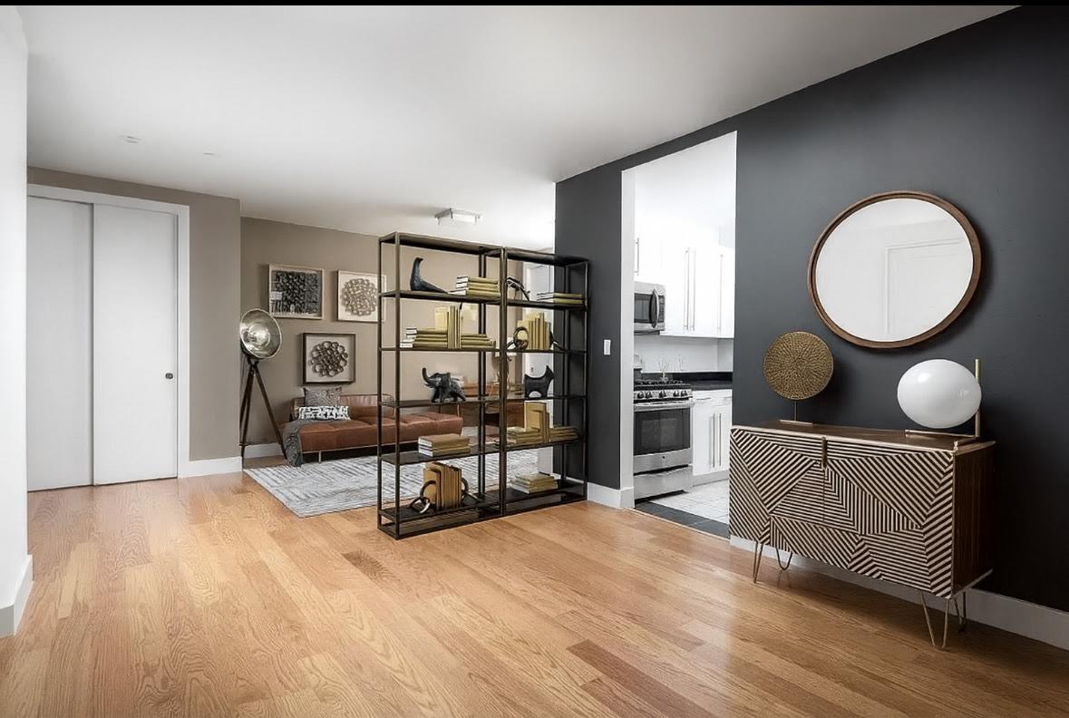 50 Murray Street, Unit 603 Manhattan, NY 10007 - Photo 3 of 3 a living room with furniture a rug and a large window