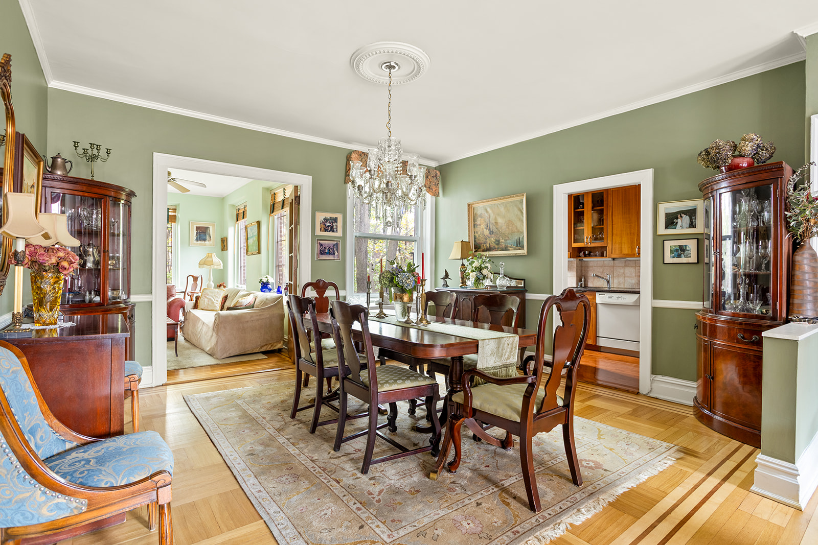 34-27 79th Street, Unit 42 Queens, NY 11372 - Photo 2 of 15 a view of a dining room with furniture a chandelier and wooden floor