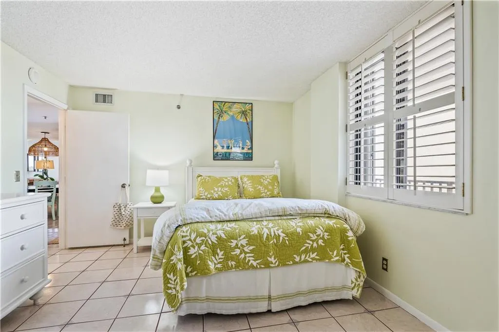 a bedroom with two beds and a window