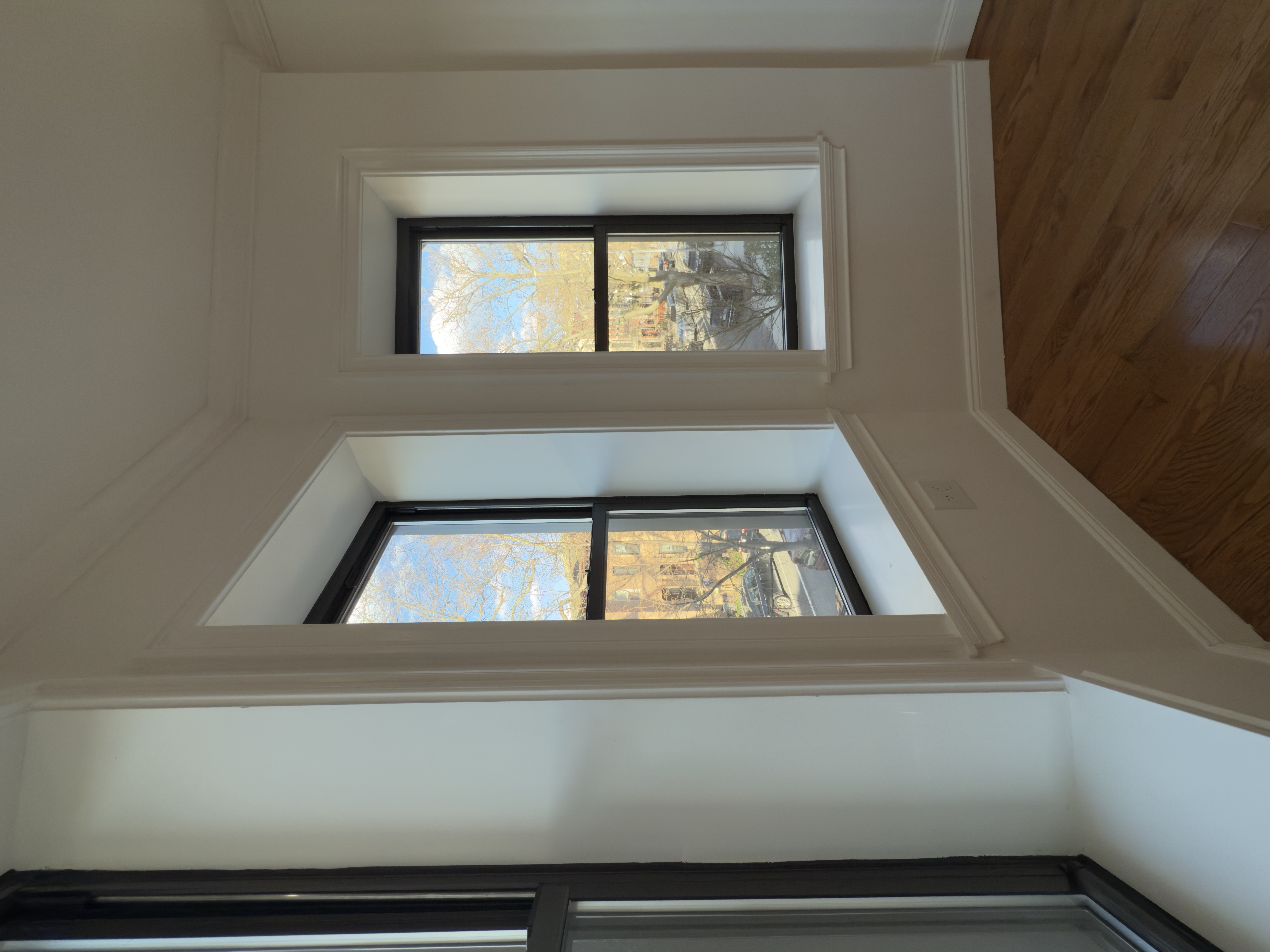 82 74th Street Brooklyn, NY 11209 - Photo 14 of 21 a view of an empty room with wooden floor and a window