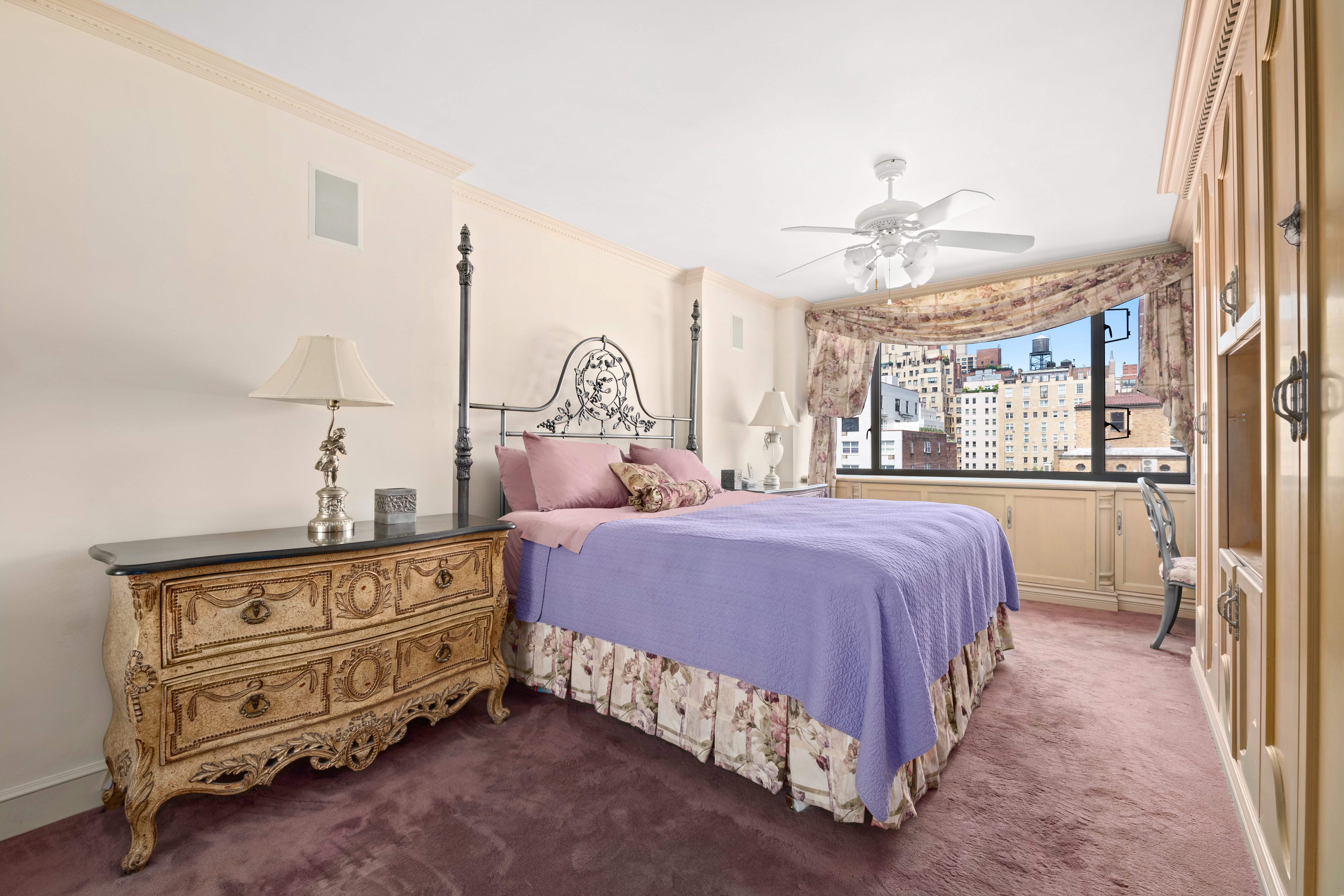 333 East 69th Street, Unit 10J Manhattan, NY 10021 - Photo 5 of 12 a bedroom with a bed and a chandelier