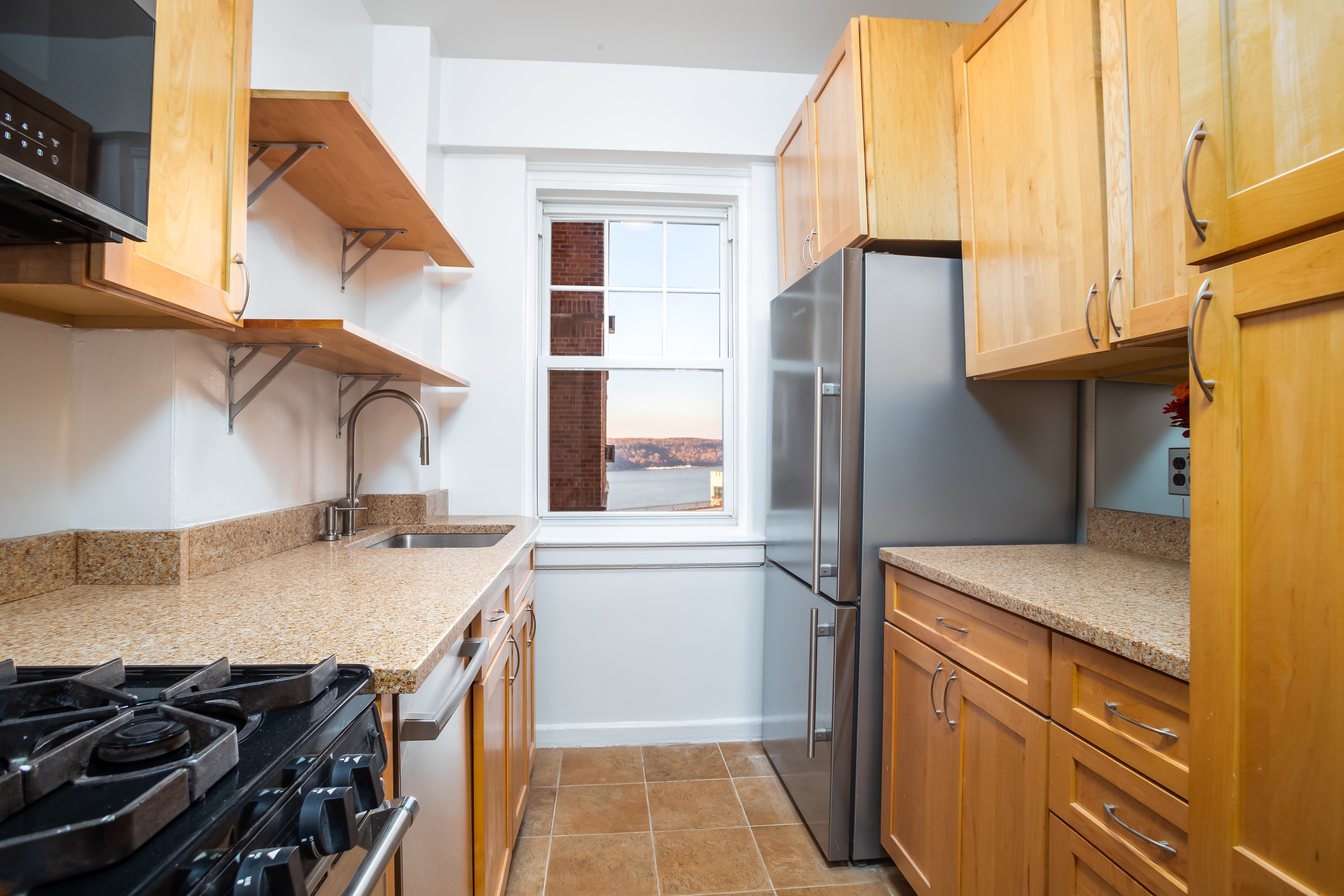 180 Cabrini Boulevard, Unit 37 Manhattan, NY 10033 - Photo 10 of 35 a kitchen with a sink stove and refrigerator