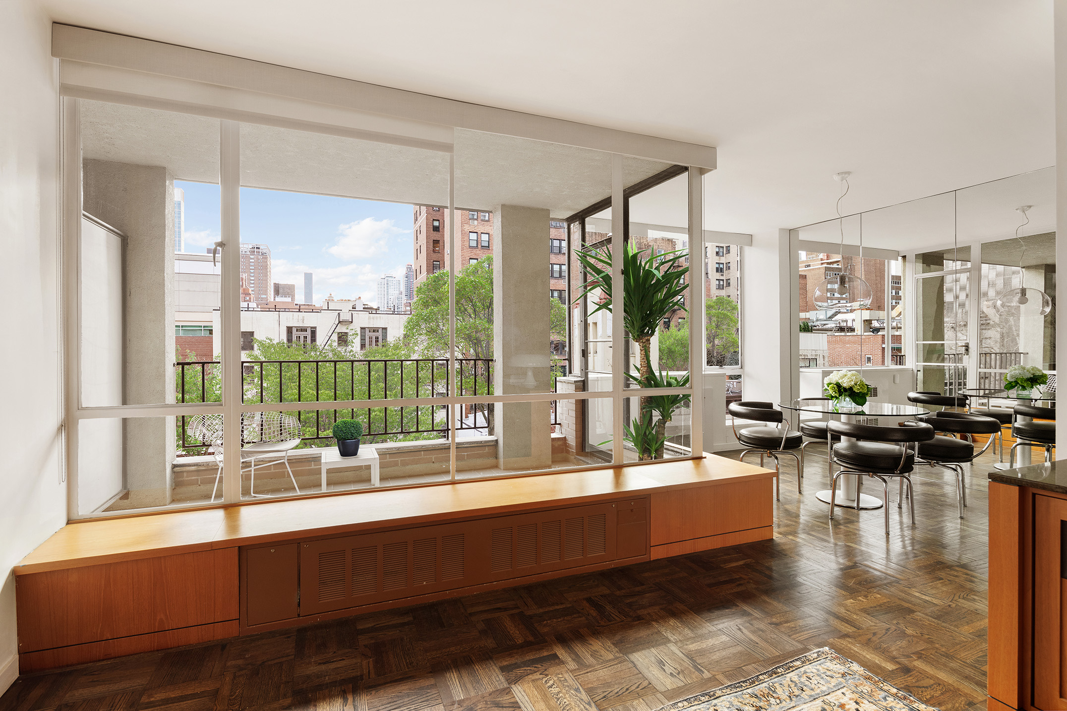 a living room with furniture and floor to ceiling windows