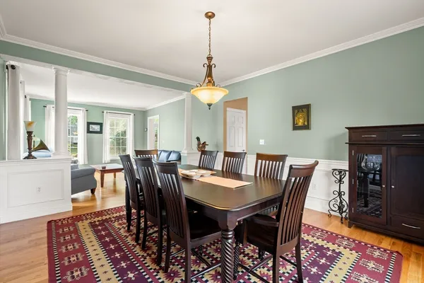 a view of a dining room with furniture window and wooden floor