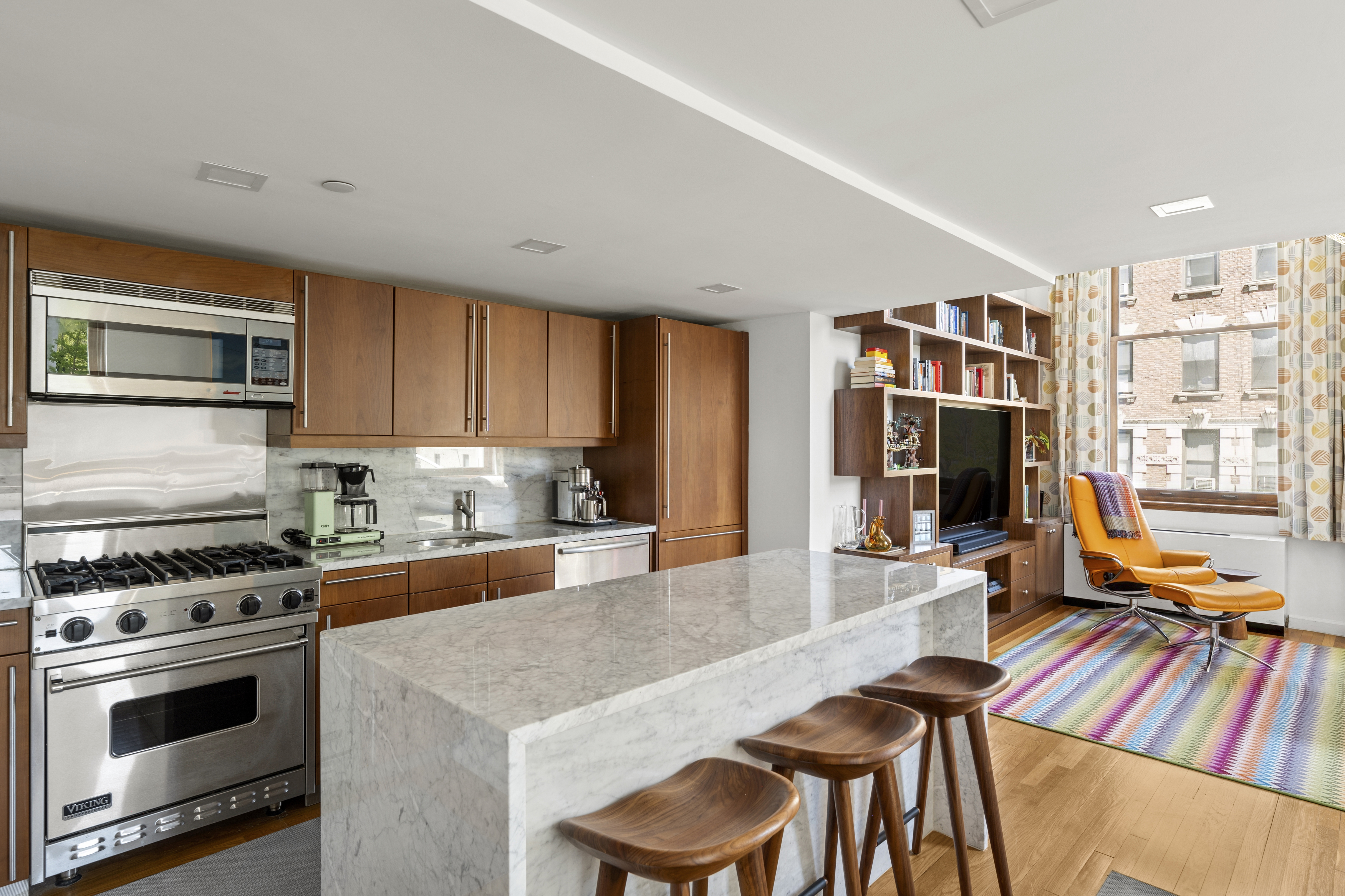 305 2nd Avenue, Unit 325 Manhattan, NY 10003 - Photo 5 of 22 a kitchen with stainless steel appliances a stove a sink dishwasher and cabinets with wooden floor