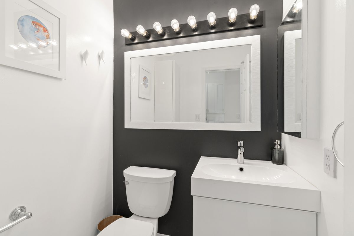 75 Poplar Street, Unit 2J Brooklyn, NY 11201 - Photo 8 of 14 a bathroom with a toilet sink and mirror