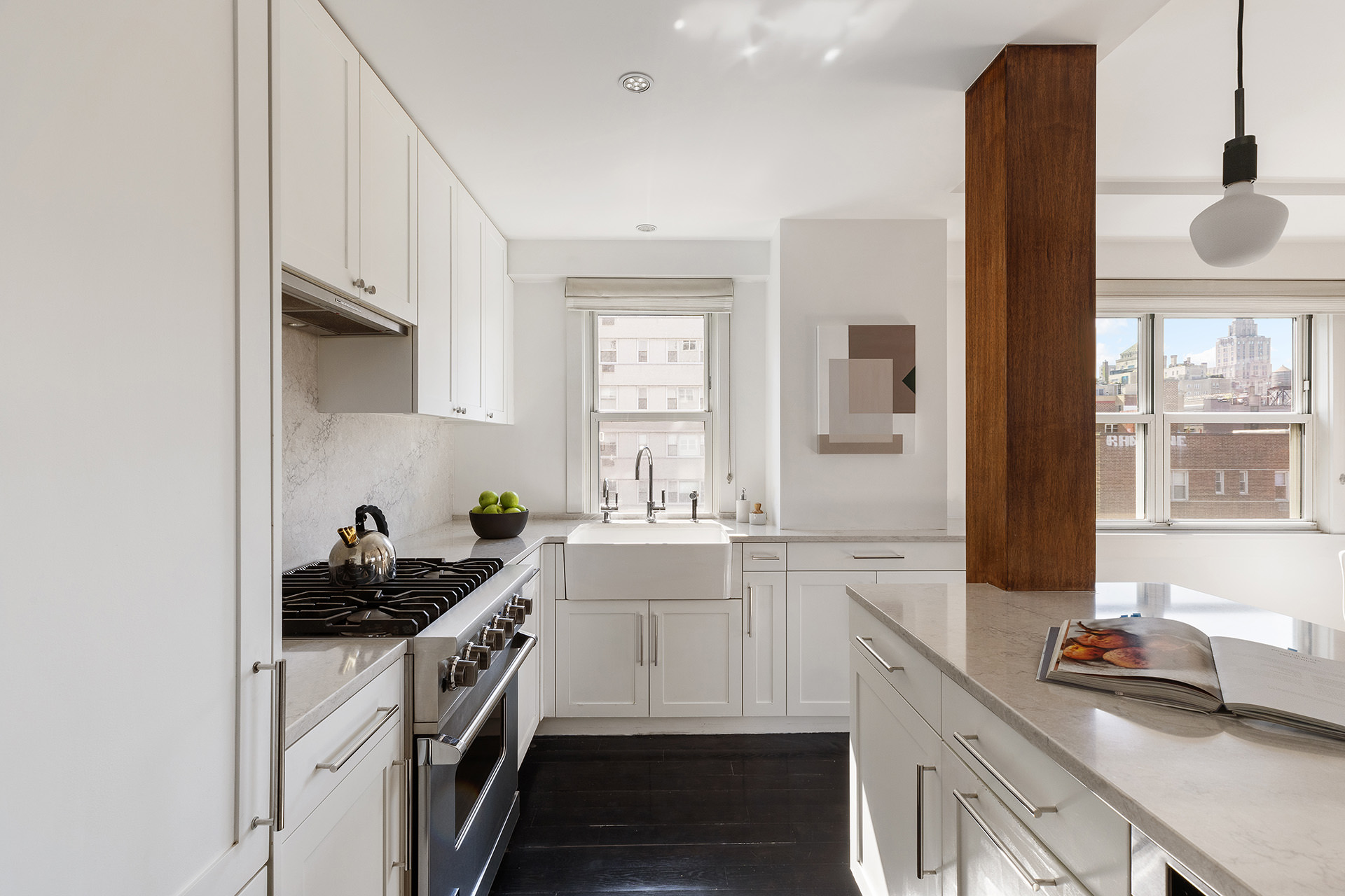 101 West 12th Street, Unit 8RS Manhattan, NY 10011 - Photo 7 of 19 a kitchen with a sink dishwasher a stove and white cabinets with wooden floor