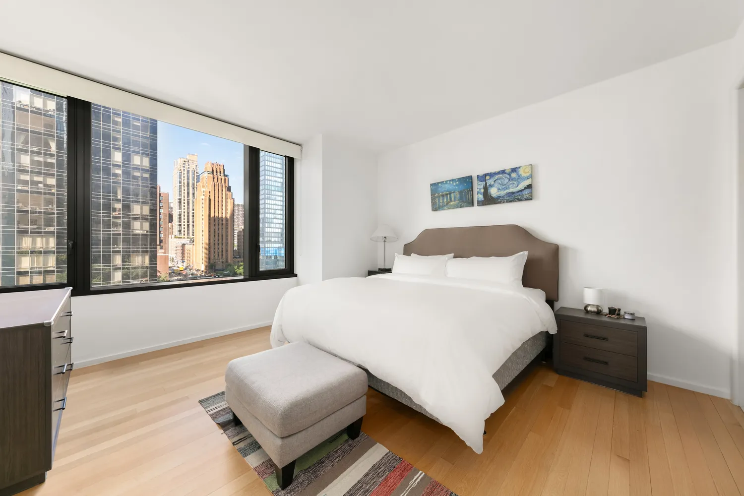 a bedroom with a bed and a large window