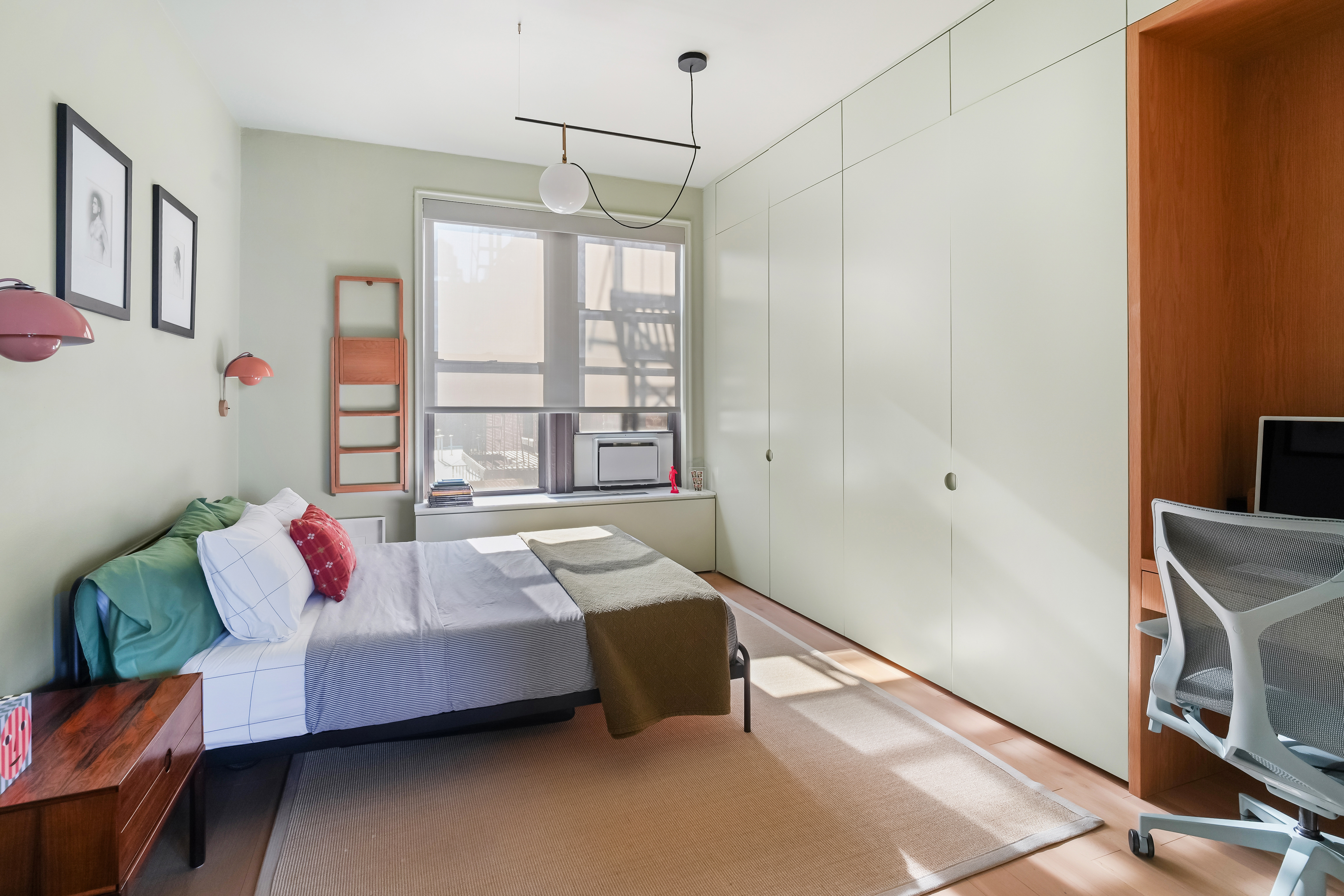 265 Riverside Drive, Unit 11F Manhattan, NY 10025 - Photo 14 of 18 a bedroom with furniture and a chandelier