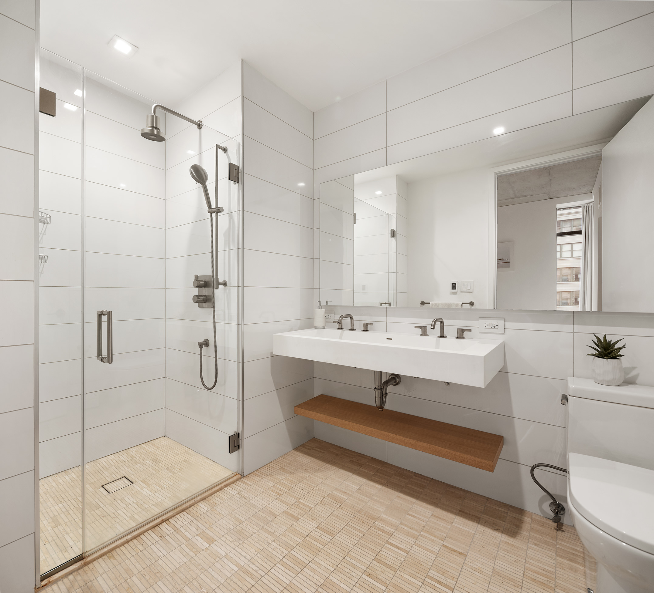 98 Front Street, Unit 8T Brooklyn, NY 11201 - Photo 8 of 18 a bathroom with a sink toilet and shower